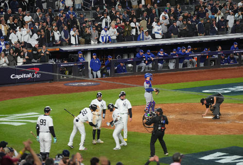 ヤンキース対ドジャース　8回裏ヤンキース1死一、三塁、トーレス（左から4人目）の3点本塁打で盛り上がるヤンキースナインを前にベンチで肩を落とすドジャースナイン（撮影・菅敏）