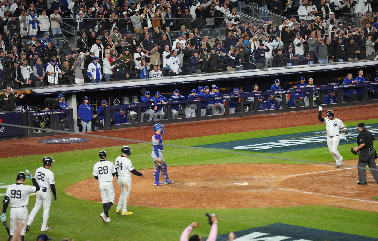 ヤンキース対ドジャース　8回裏ヤンキース1死一、三塁、トーレス（右）の3点本塁打で盛り上がるヤンキースナインを前にベンチで肩を落とすドジャースナイン（撮影・菅敏）