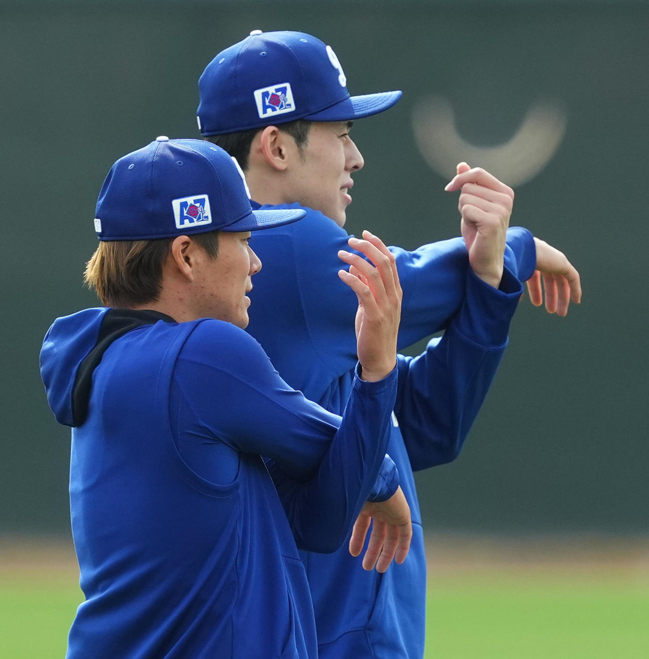 25年2月13日　ドジャース佐々木（後方）と並んでストレッチをする山本（撮影・菅敏）