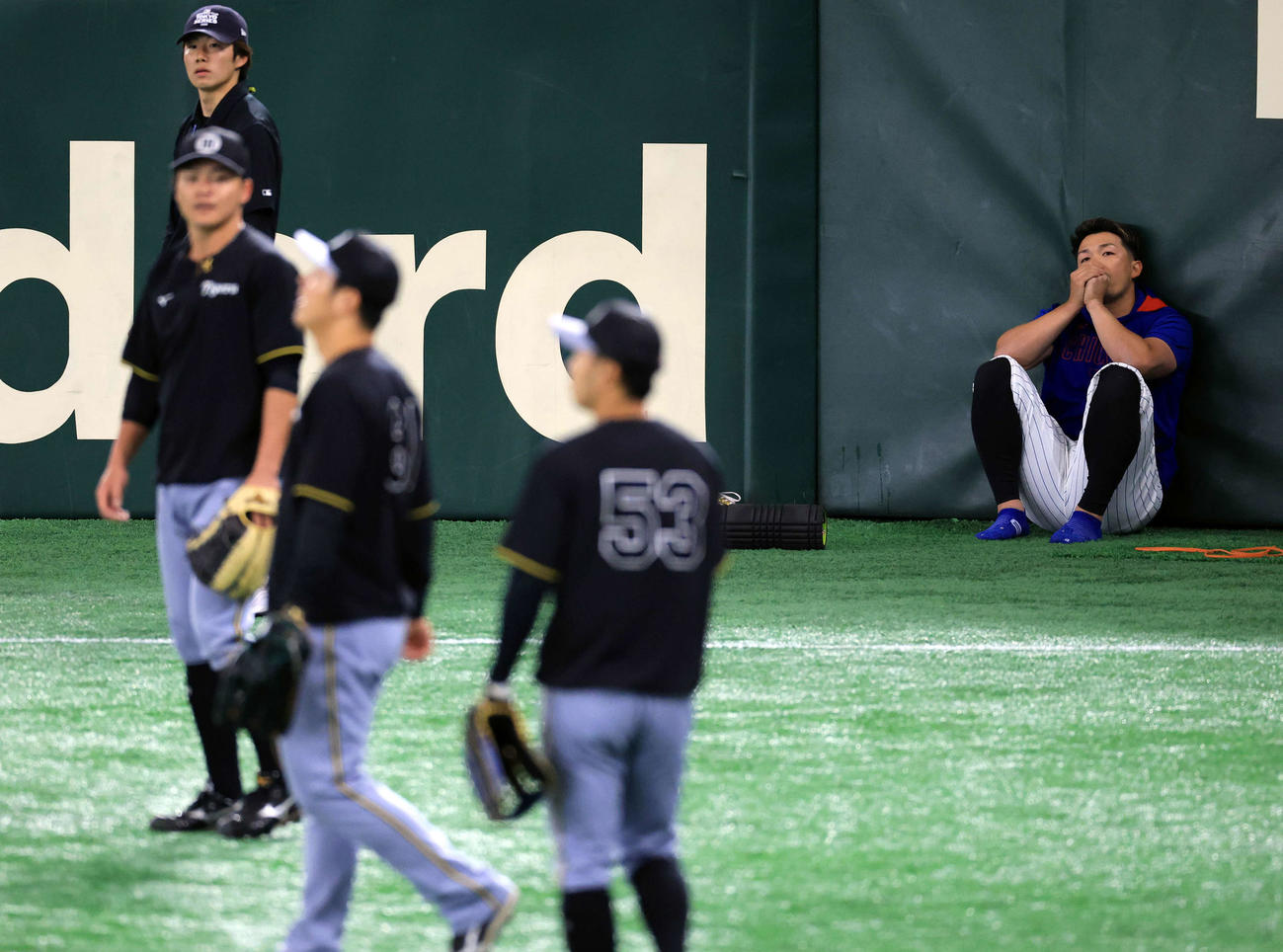 阪神対カブス　試合前練習をする阪神の選手たちを見つめるカブス鈴木（撮影・浅見桂子）