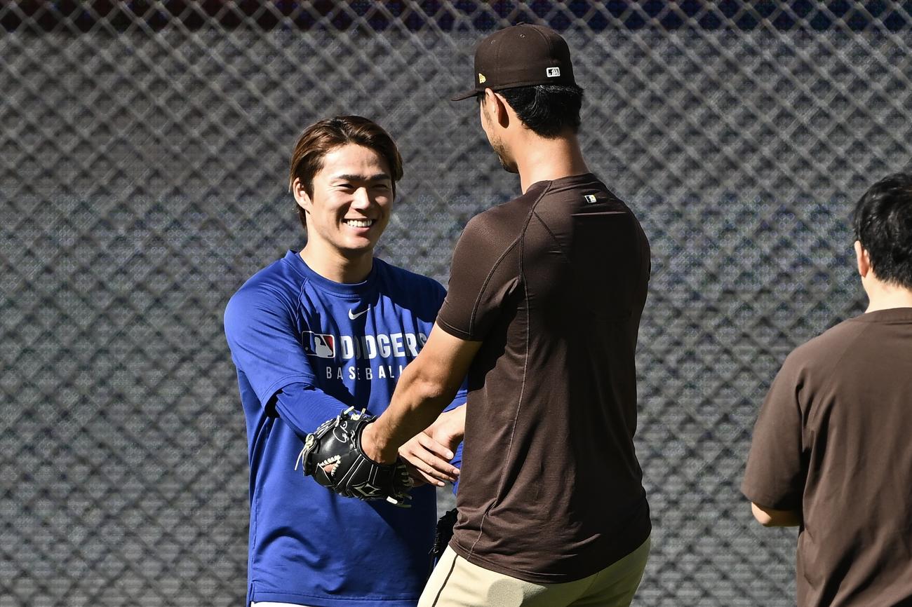 ドジャース対パドレス　試合前練習でドジャース山本（左）はパドレスのダルビッシュと握手を交わす（撮影・滝沢徹郎）