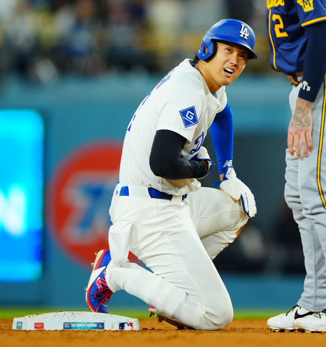ドジャース対ブルワーズ　6回裏ドジャース2死一塁、チュラング（右）と交錯しながらも二盗を決めた大谷はお腹を痛そうにおさえる（撮影・垰建太）