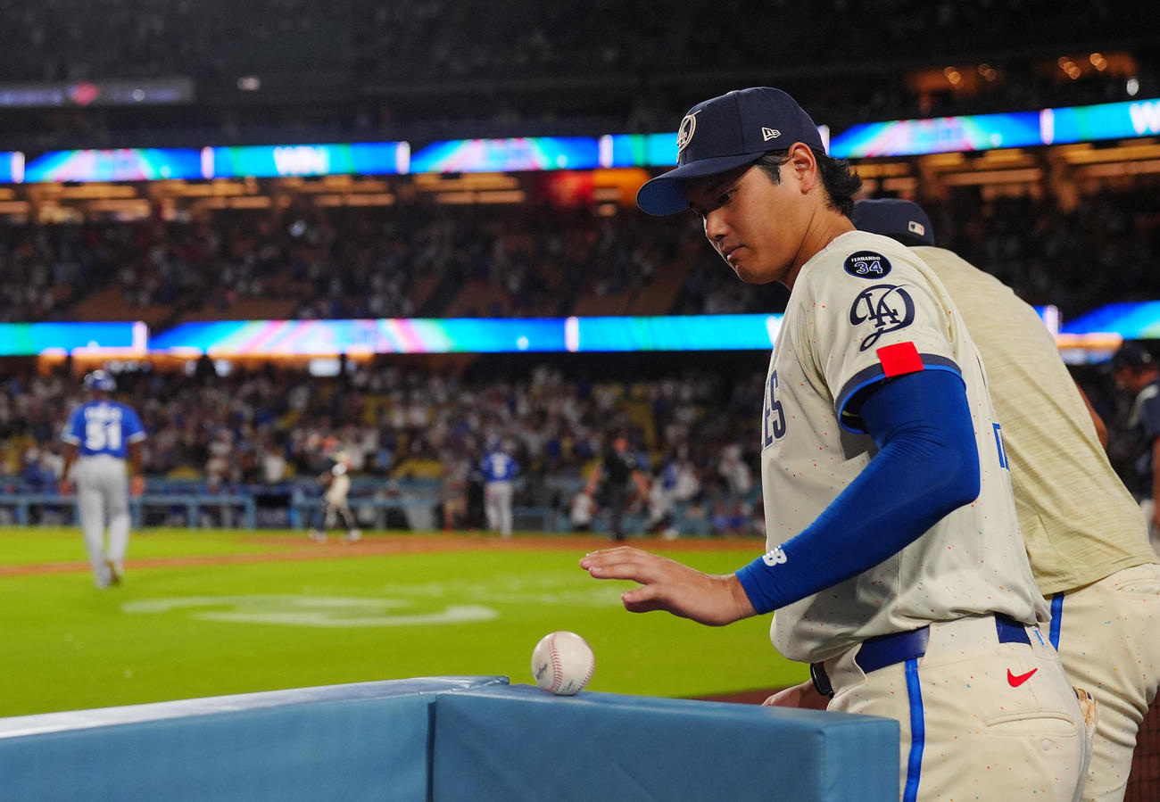 ドジャース対ブルージェイズ　ブルージェイズに勝利し手にしていたボールをベンチの角にそっと置きナインを出迎えに行くドジャース大谷（撮影・垰建太）
