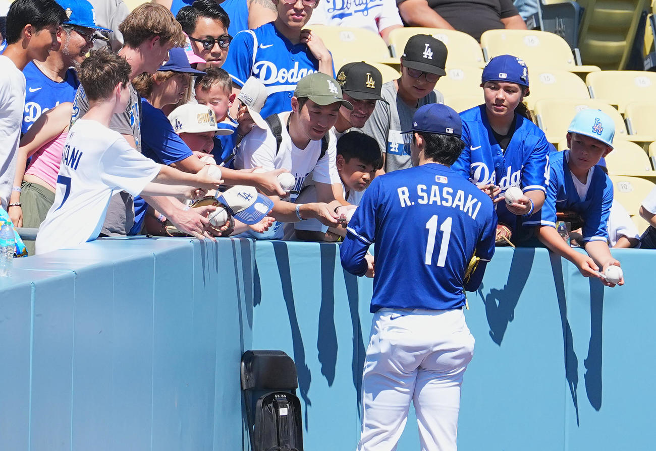 ドジャース対ダイヤモンドバックス　試合前、ファンにサインをするドジャース佐々木（撮影・菅敏）