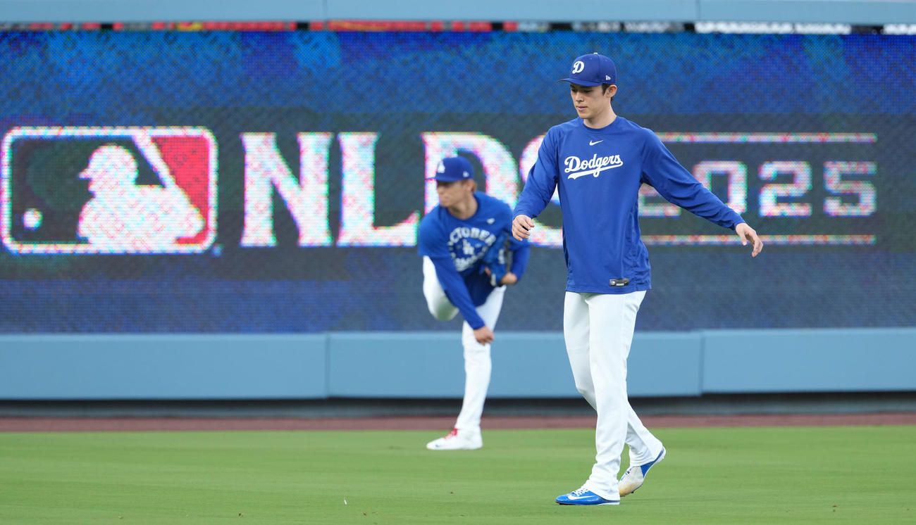 地区シリーズ・ドジャース対フィリーズ　前日練習でキャッチボールをする山本（後方）を横目に調整するドジャース佐々木（撮影・菅敏）