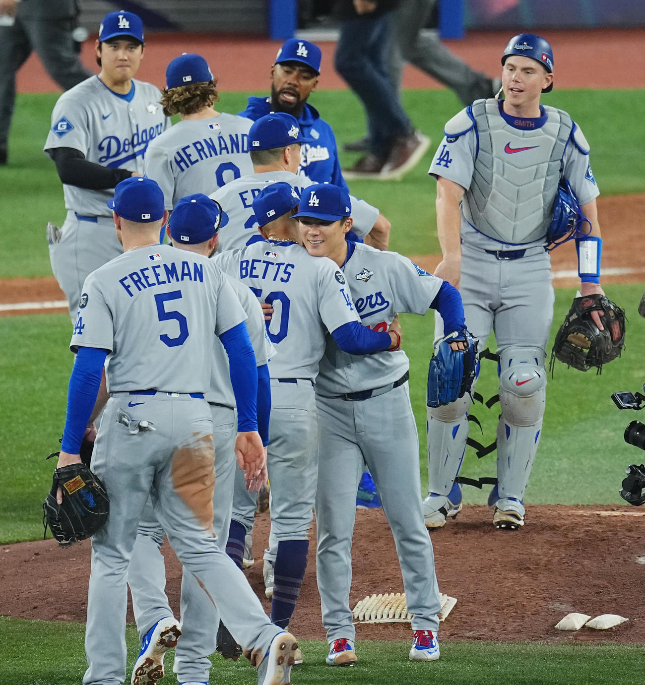ブルージェイズ対ドジャース　完投勝利を飾り、ベッツ（中央左）らナインに祝福される山本（撮影・菅敏）