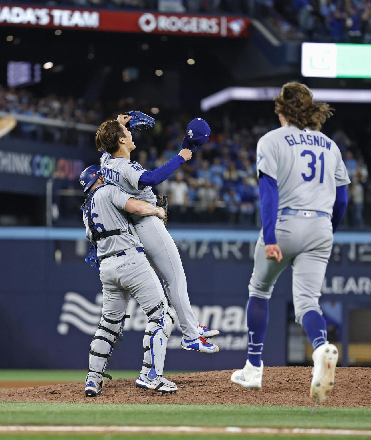 米大リーグ、ブルージェイズとのワールドシリーズ第7戦を制して2連覇を達成し、捕手スミスに抱きかかえられるドジャースの山本由伸＝2日、トロント（共同）