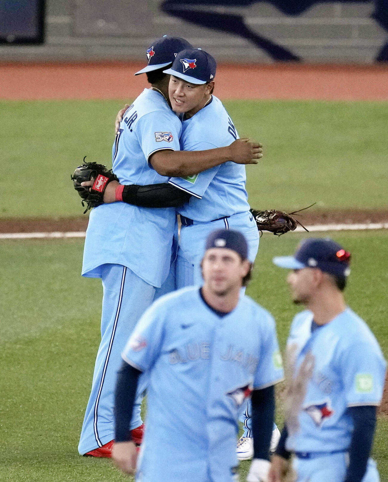 ドジャースに勝利し、ゲレロと抱き合って喜ぶブルージェイズ・岡本（奥右）＝トロント（共同）