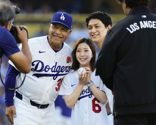 始球式を終え、ドジャースのロバーツ監督(左)と記念写真に納まるフィギュアスケート・ペアの三浦璃来さん(中央)と木原龍一さん=ロサンゼルス(共同)