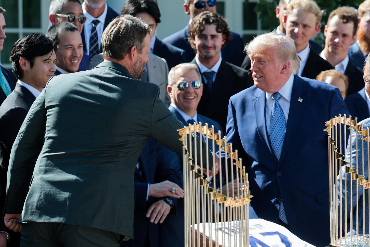 ホワイトハウスのローズガーデンで開かれたレセプションでトランプ米大統領と握手する昨季引退したカーショーさん。左端は大谷翔平（ロイター）