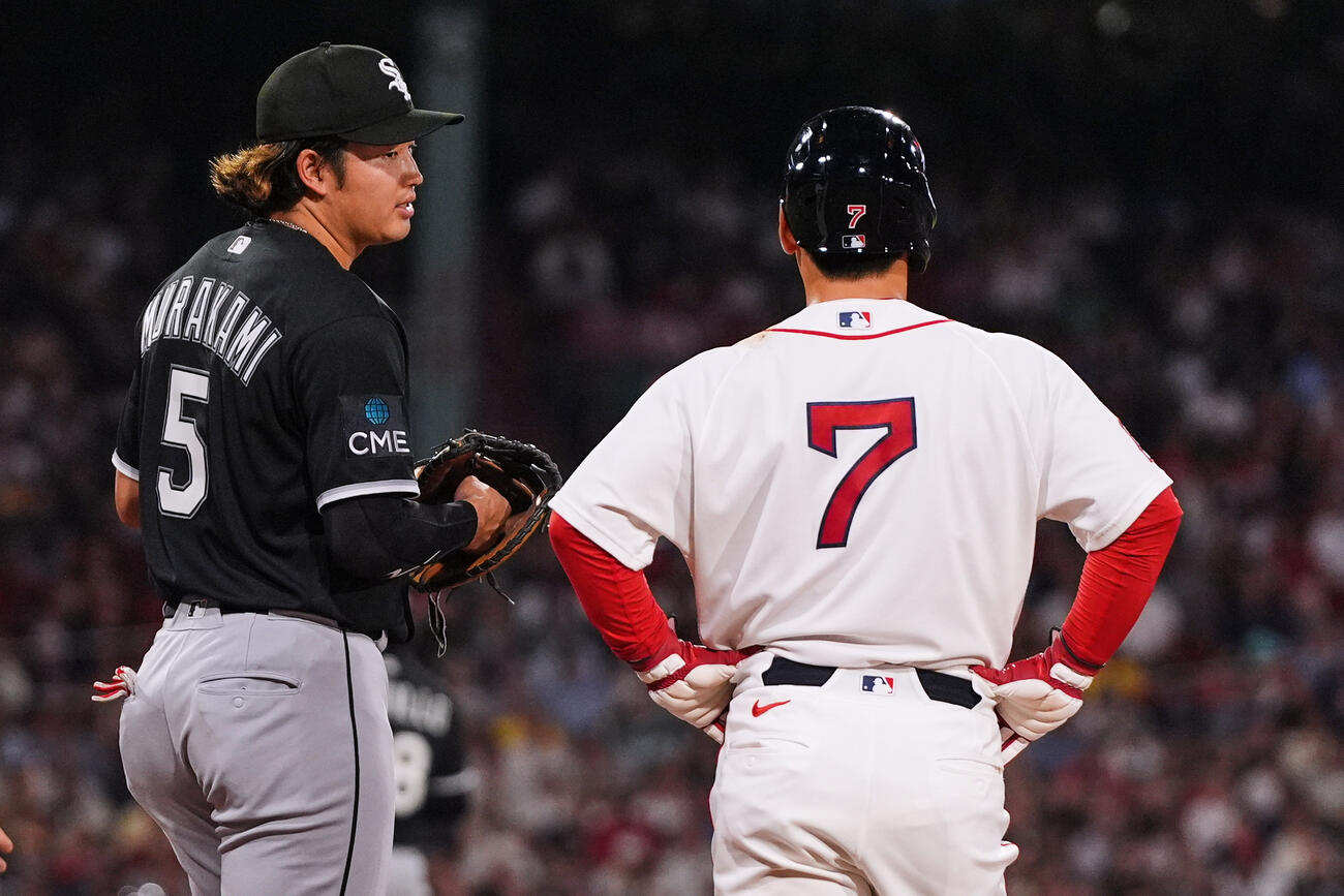 4回、出塁したレッドソックス吉田正尚（右）と言葉を交わすホワイトソックス村上宗隆（AP）