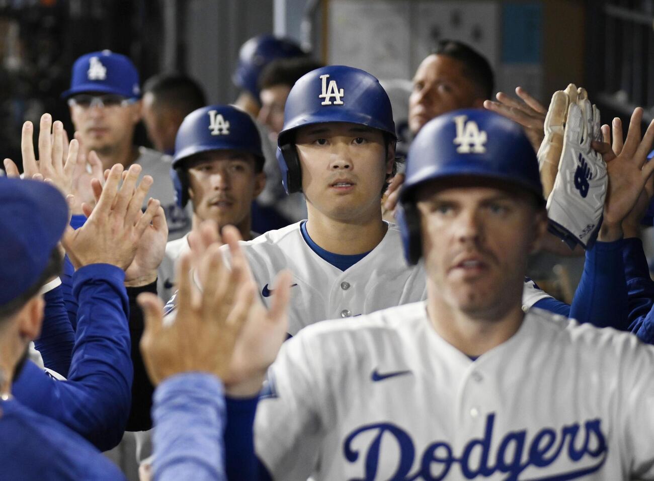 カージナルス戦の3回、ベッツの3点二塁打で生還し、タッチを交わすドジャースの二走大谷（手前から2人目）＝ロサンゼルス（共同）