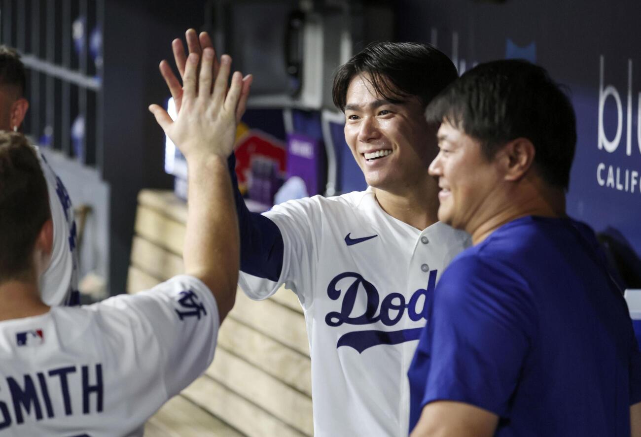 レッズ戦で7回を投げ終え、ベンチでタッチを交わすドジャース・山本＝ロサンゼルス（共同）