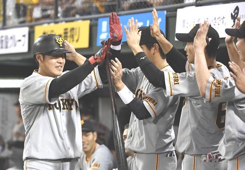 ４回表巨人無死、右越えソロ本塁打を放った岡本（左）はナインから祝福を受ける（撮影・鈴木みどり）