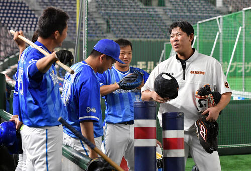 巨人対DeNA 練習中に話す巨人山口俊(右)とDeNAスタッフら(撮影・滝沢徹郎)