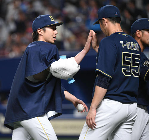 中日対オリックス　２勝目を挙げた金子千尋（左）はウイニングボールを手にＴ－岡田とタッチをかわす（撮影・渦原淳）