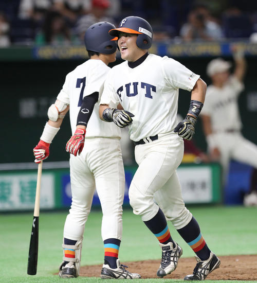 福岡大対福井工大　５回裏福井工大無死、左翼にソロ本塁打を放った鈴木（右）は満面の笑みで生還する（撮影・垰建太）