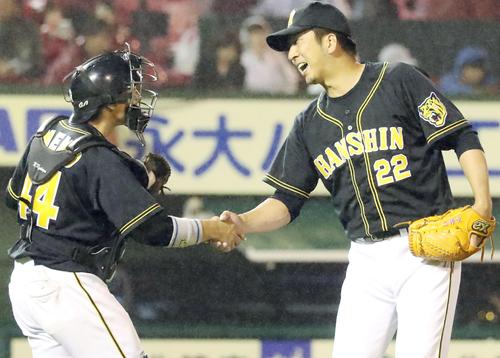 ９回を無失点ピッチングで締め梅野（左）と握手する藤川（撮影・加藤哉）
