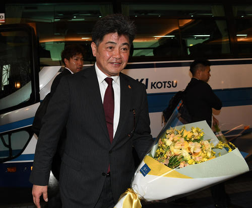 宮崎入りし宿舎で関係者から歓迎の花束を受ける工藤公康監督、後方は柳田悠岐（撮影・今浪浩三）