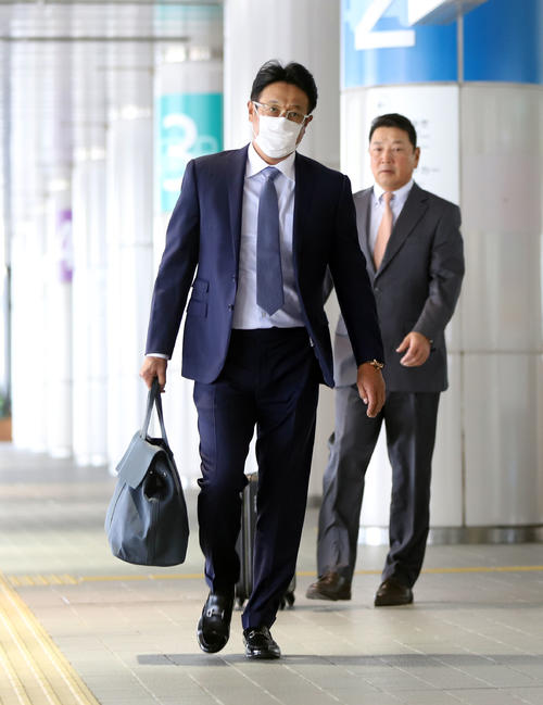 広島空港に到着した巨人宮本コーチ(左)と吉村コーチ(撮影・垰建太)