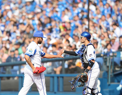 DeNA対巨人 7回表巨人2死一、二塁、打者坂本勇のとき、一塁走者吉川尚の二盗を封じた伊藤光(右)とタッチを交わすエスコバー(撮影・林敏行)