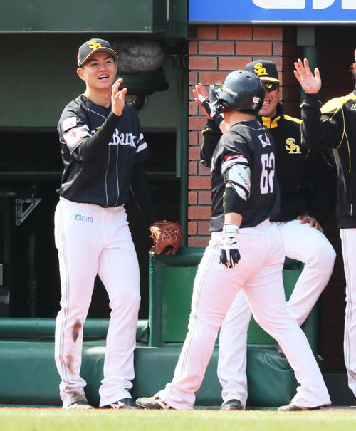 楽天対ソフトバンク　2回表ソフトバンク2死一、二塁、右越え3点本塁打を放った甲斐（右）をタッチで迎える高橋礼（撮影・足立雅史）