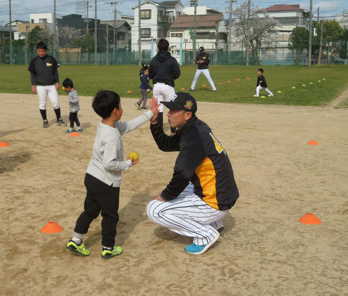 子どもとタッチする元阪神の今成亮太氏（撮影・磯綾乃）