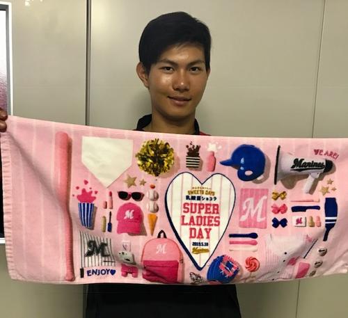 乳酸菌ショコラSUPERLADIESDAYフォトフェイスタオルを手に笑顔のロッテ藤原（球団提供）