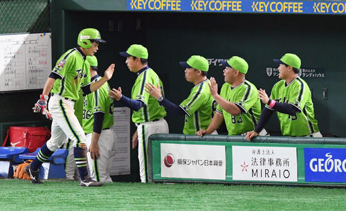 巨人対ヤクルト　3回表ヤクルト無死三塁、雄平の適時打から生還した山崎（手前）は小川監督（後列左から2人目）とタッチを交わす（撮影・滝沢徹郎）