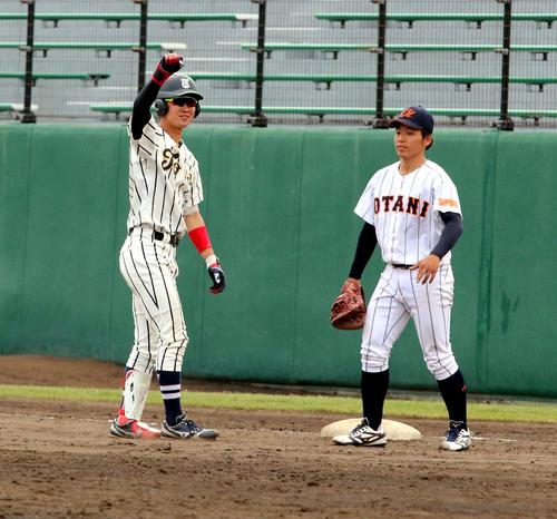 東海大北海道対札幌大谷大　8回1死二、三塁で左前適時打を放ち塁上で右手を挙げる東海大北海道の浦田（撮影・永野高輔）