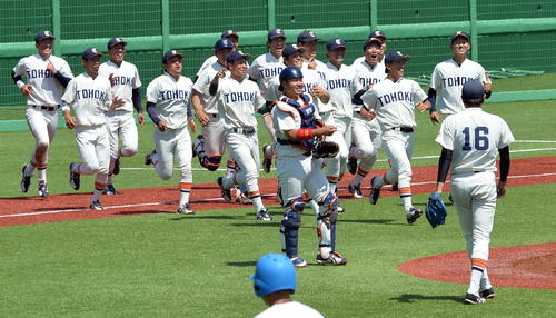 優勝を決めた瞬間、9回を締めたエース津森（16番）の元に駆け寄る東北福祉大ナイン（撮影・中島正好）