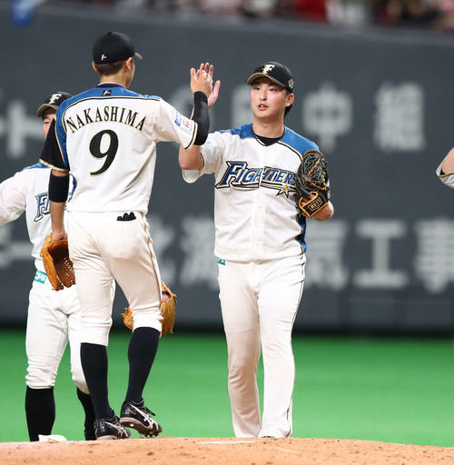 日本ハム対広島　試合後、ナインとハイタッチする石川直（右）（撮影・黒川智章）