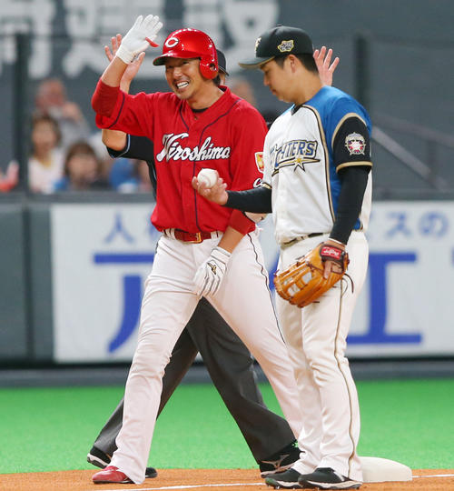 日本ハム対広島　1回表広島無死、右越え三塁打を放ちベンチに笑顔で手を振る長野（左）（撮影・垰建太）