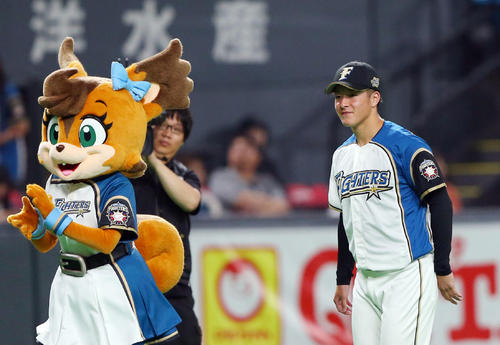 日本ハム対巨人　試合前、ファンとのハイタッチを終え笑顔で引き揚げる日本ハム吉田（撮影・垰建太）