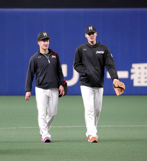 中日対日本ハム　試合前、言葉を交わしながら引き揚げる日本ハム有原と吉田輝（左）（撮影・佐藤翔太）