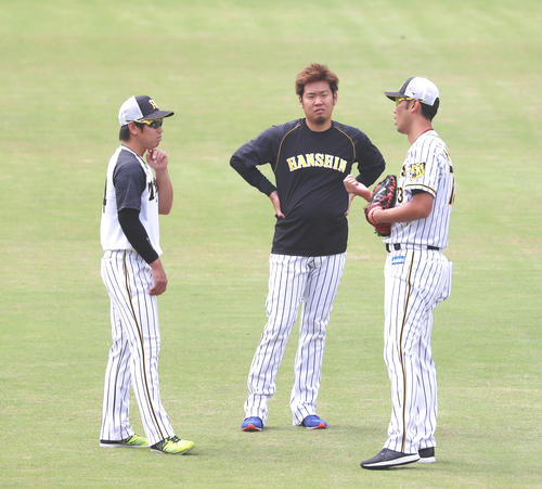 阪神対広島　練習中、金村投手コーチ（右）は梅野（左）を交え西と話し込む（撮影・加藤哉）