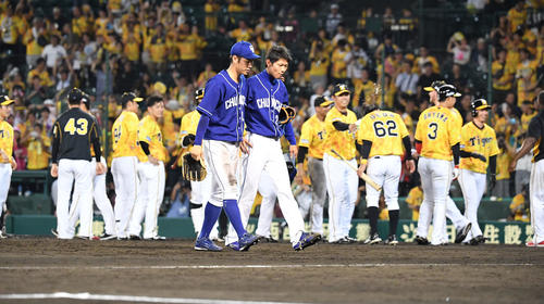 9回裏阪神無死一塁、ヤンハービス・ソラーテに左越えサヨナラ本塁打を打たれた岡田俊哉（右）はガックリ引き揚げる（撮影・奥田泰也）