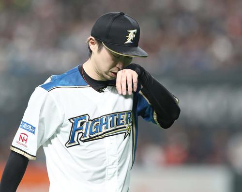 日本ハム対ソフトバンク　1回表、4失点し汗を拭きながらベンチに戻る金子（撮影・黒川智章）