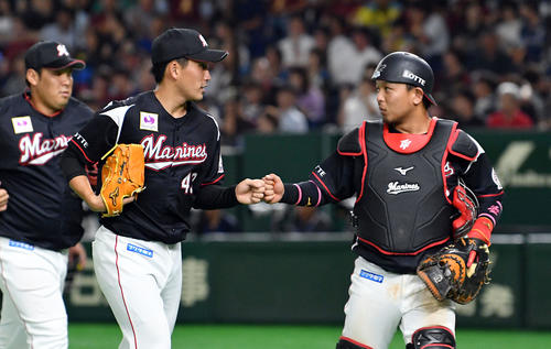 日本ハム対ロッテ　5回を投げ終えロッテ田村（右）とタッチを交わす小島（撮影・滝沢徹郎）