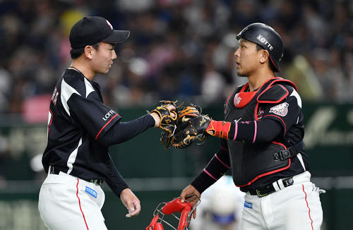 日本ハム対ロッテ　8回裏を投げ終えロッテ田村（右）とタッチを交わす中村稔（撮影・滝沢徹郎）