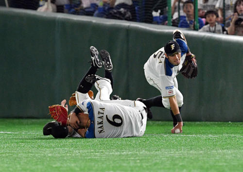 日本ハム対ロッテ　9回表ロッテ無死、レアードの飛球を追って渡辺（奥）と交錯し頭を押さえる中田（手前）。右は大田（撮影・滝沢徹郎）