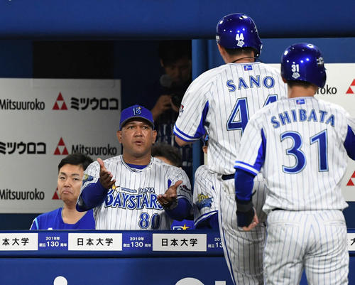 DeNA対巨人　9回裏DeNA1死一塁、ラミレス監督は2点本塁打を放った佐野（右から2人目）とタッチをかわす（撮影・山崎安昭）