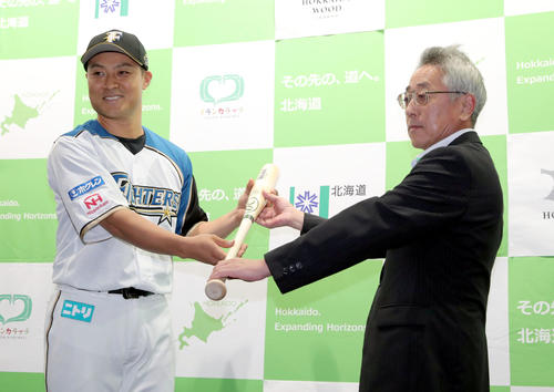 日本ハム対ソフトバンク　試合前、ダケカンババットを贈呈され笑顔の日本ハム田中賢（左）（撮影・佐藤翔太）
