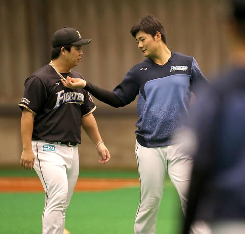 日本ハム横尾がつけている中田のネックレスに興味津々の清宮（右）（撮影・佐藤翔太）