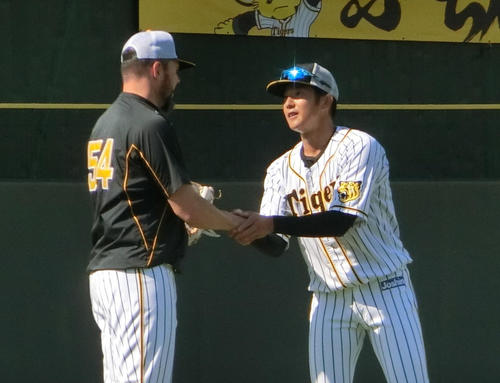 鳴尾浜で握手を交わす阪神メッセンジャー（左）と横田（撮影・奥田隼人）