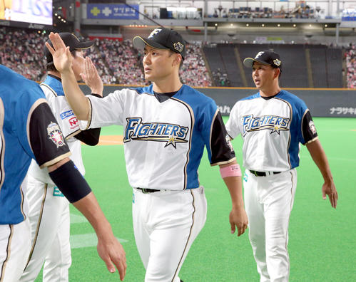日本ハム対オリックス　日本ハム栗山監督とタッチをして引き揚げる田中賢（中央）（撮影・佐藤翔太）