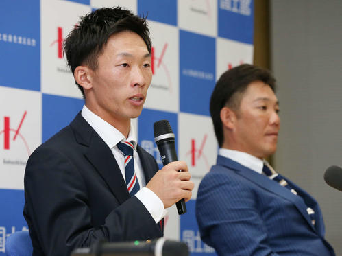 ロッテの3位指名を受けて、あいさつする国士舘大の高部（手前）、奥はロッテOBで同大野球部の辻監督（撮影・丹羽敏通）