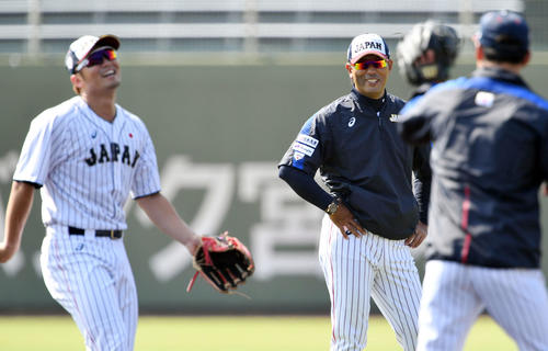 内野でノックを受ける広島鈴木（左手前）に笑顔を見せる侍ジャパン稲葉監督（奥）（撮影・滝沢徹郎）