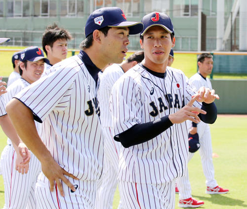 ボールの握りについて秋山（左）に話す山田（撮影・浅見桂子）