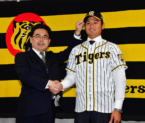 阪神谷本修球団副社長（左）と握手を交わす中田（撮影・清水貴仁）
